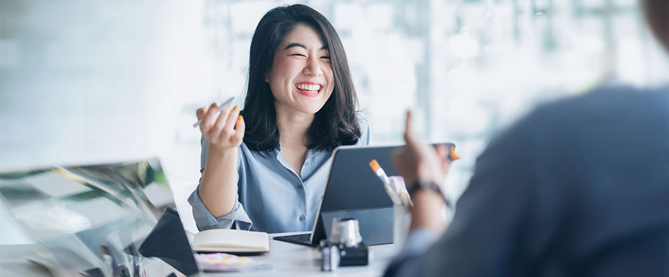 Woman laughing while working